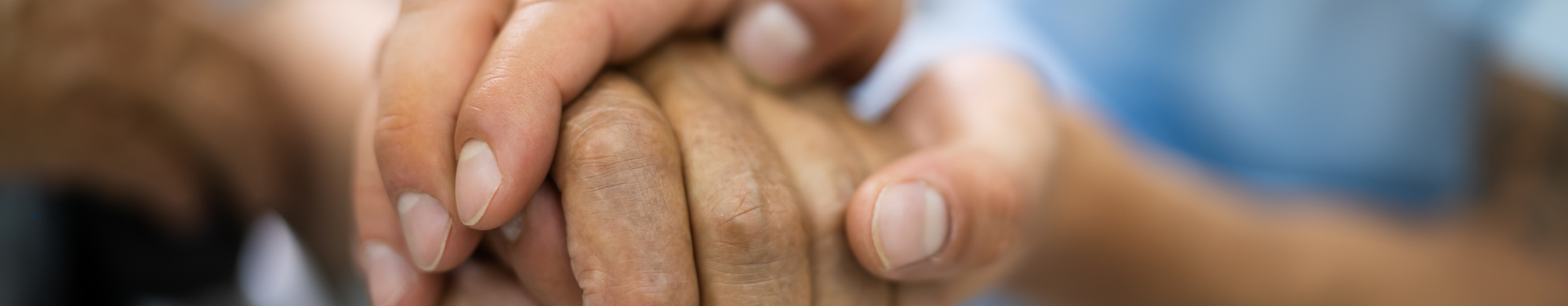 Healthcare provider holding a person's hand.