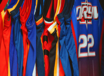 a clothing rack holding basketball jerseys