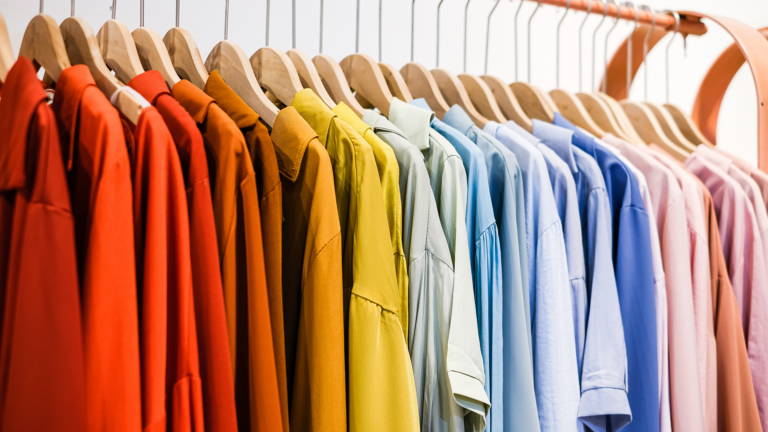 colorful blouses on a clothing rack in a store
