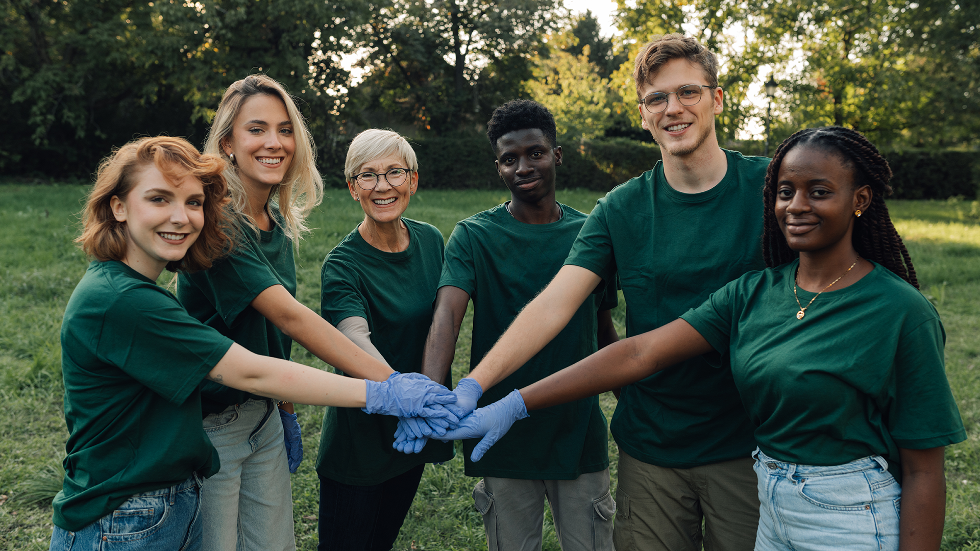 volunteers standing in a semi-circle with their hands joined